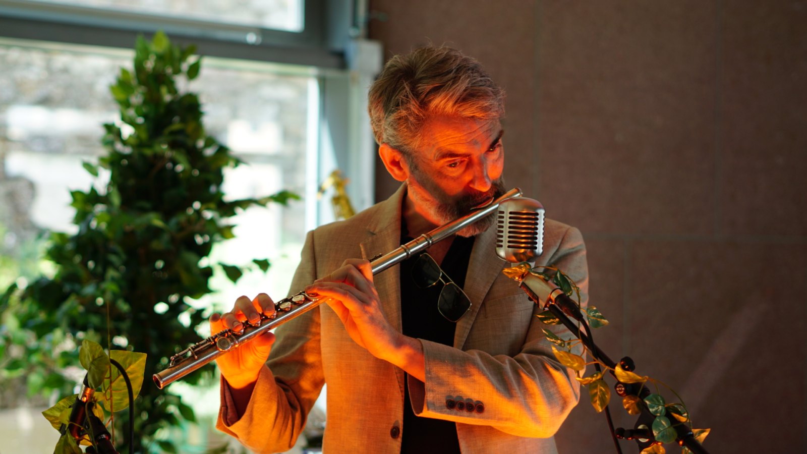 Thunderclap Murphy playing flute at the microphone.